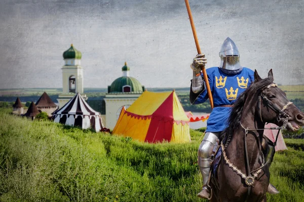 Armored knight on warhorse over old medieval castle — Stock Photo, Image