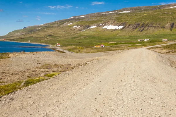 Landsbygdens grus väg till unadsdalur village - Island. — Stockfoto