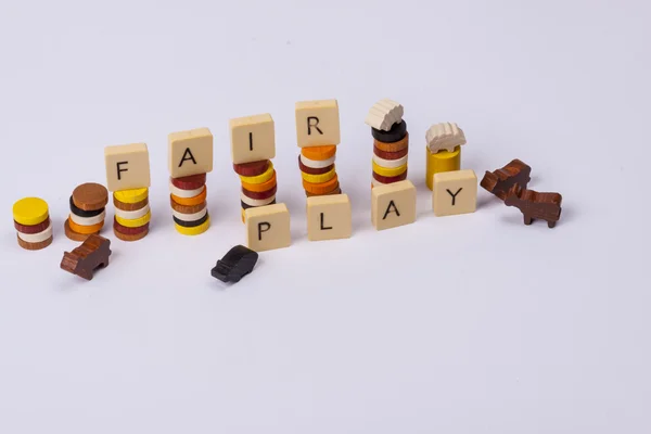 Fair play game - wooden column on white background. — Stock Photo, Image