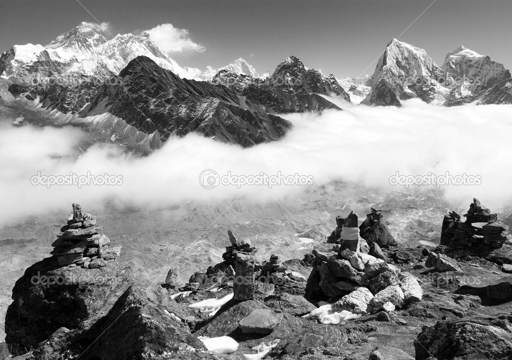 view of everest with stone mans from gokyo ri and clouds above ngozumba glacier