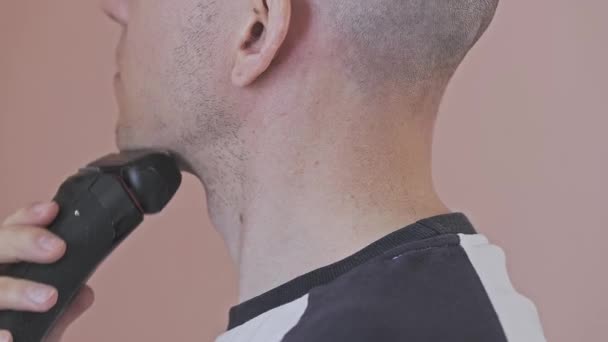 Bald Young Man Shaves His Neck Using Electric Shaver Pink — Stock Video