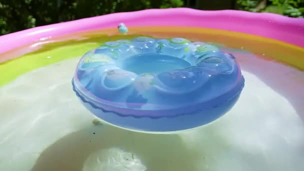Blue Inflatable Swim Ring Floating Spinning Inflatable Pink Pool Bright — Stock Video