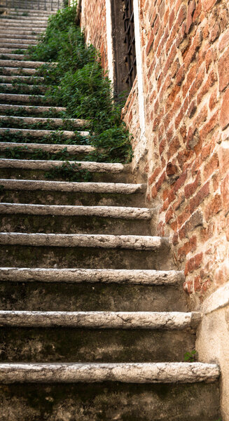 The perspective of the ancient steps in the old patio. Verona, northern Italy