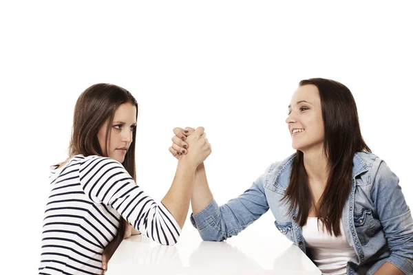 Happy and strained teenager arm wrestling — Stock Photo, Image