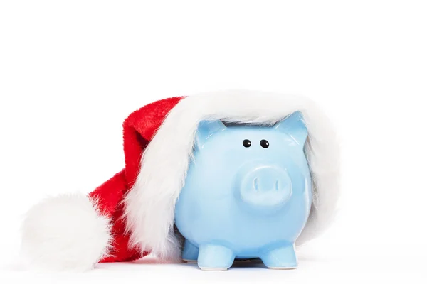 Blue piggy bank wearing santas hat — Stock Photo, Image