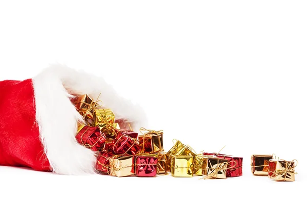 Small colorful christmas presents falling from santas hat — Stock Photo, Image