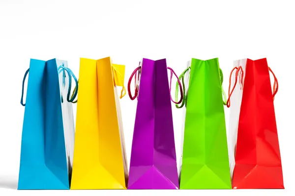 Four shopping bags in a row — Stock Photo, Image