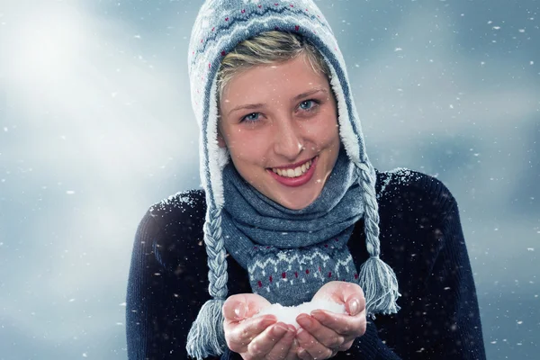 Young cute woman with a hand full of snow — Stock Photo, Image