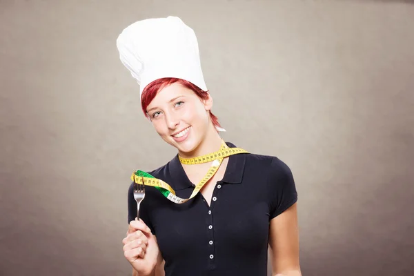 Female cook with a measuring tape — Stock Photo, Image