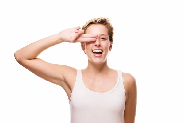 Happy woman holding fingers over her eye — Stock Photo, Image