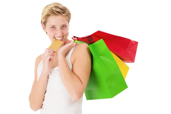 Feliz mujer de compras muerde en su tarjeta de crédito Imágenes de stock libres de derechos