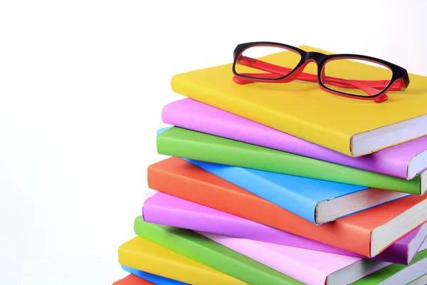Modern red and black fashion eye glasses and colorful books — Stock Photo, Image