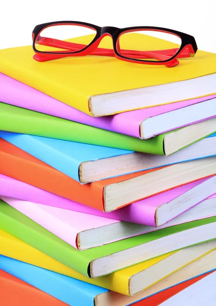 Modern red and black fashion eye glasses and colorful books — Stock Photo, Image