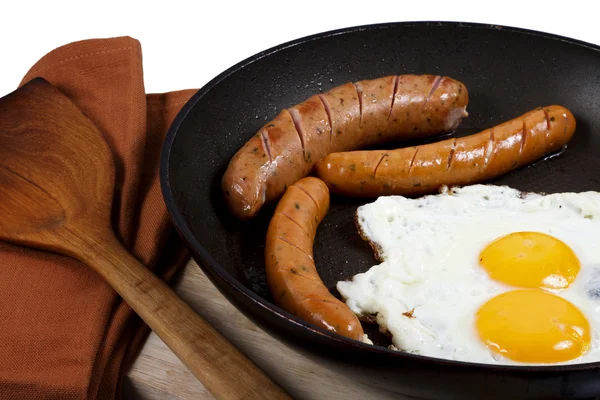 Cooking egg and veal sausage breakfast — Stock Photo, Image