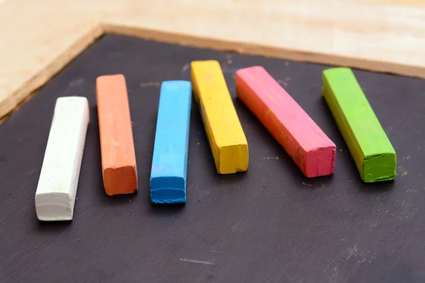 Colorful chalk on blackboard — Stock Photo, Image