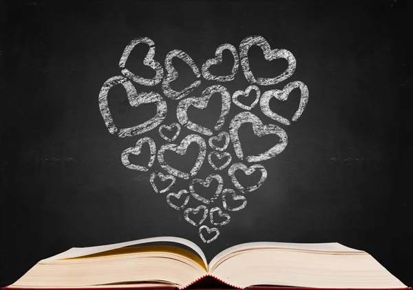Love heart shape sign on blackboard popup from book — Stock Photo, Image
