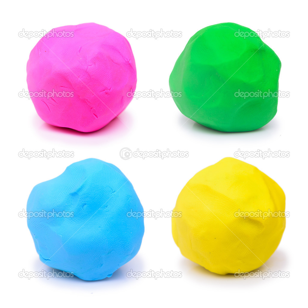 Colorful pink green blue and yellow plasticine clay on white background
