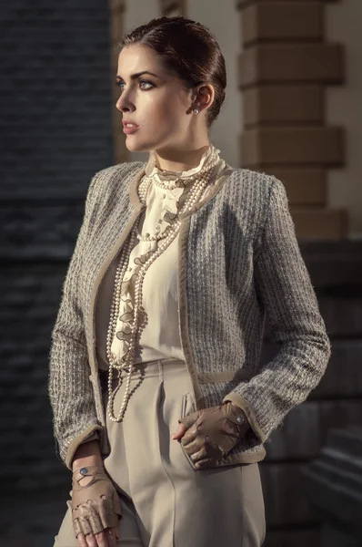 Business style woman in a beige costume