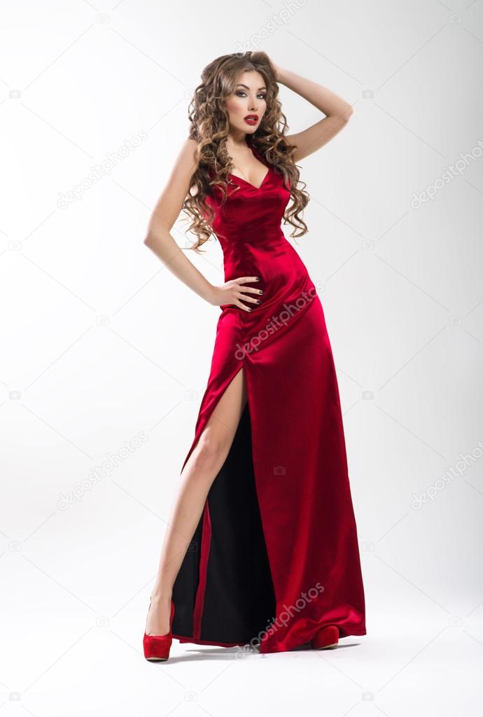Posh sexy woman in long red dress over white background