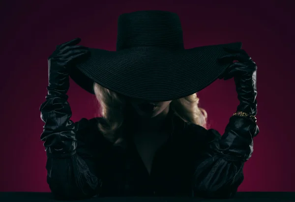 Элегантная женщина в черной шляпе — стоковое фото
