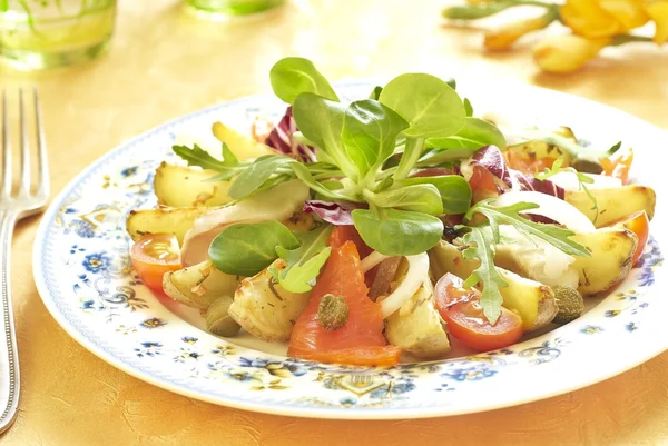 Potato salad with smoked sea bass and salmon — Stock Photo, Image