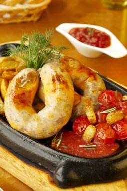 Beef sausage with roasted potatoes and tomatoes clipart