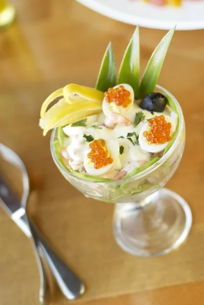 Salad with shrimps, avocado, pineapple, quail eggs and red caviar — Stock Photo, Image
