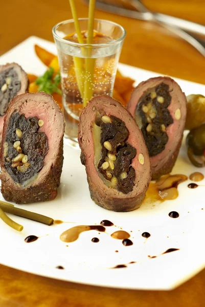 Beef rolls with prunes, cheese and pine nuts — Stock Photo, Image