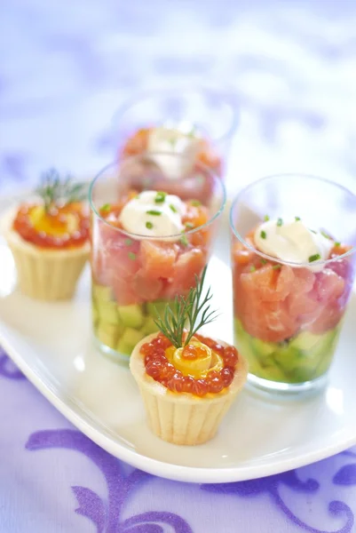 Holiday appetizers with smoked salmon and red caviar — Stock Photo, Image