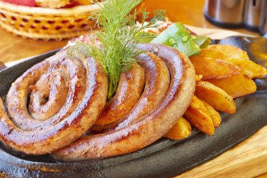 Grilled beef sausage with potatoes and tomatoes clipart