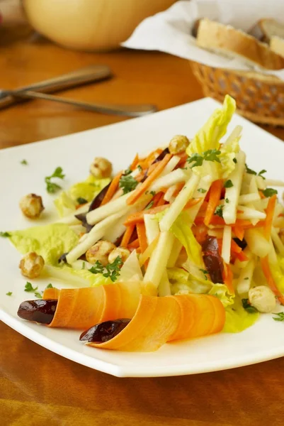 Salada com cenouras, maçãs, tâmaras e avelãs — Fotografia de Stock