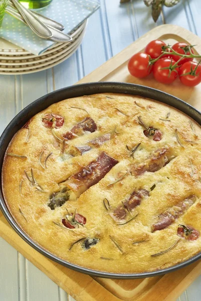 Focaccia bread with rosemary, asparagus in jamon and tomatoes — Stock Photo, Image