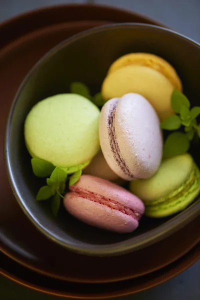 Colorful macaroons on brown plate — Stock Photo, Image