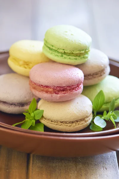 Colorful macaroons on brown plate — Stock Photo, Image