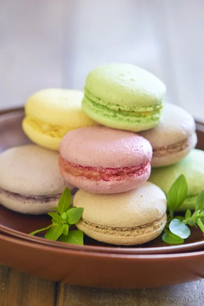 Colorful macaroons on brown plate — Stock Photo, Image