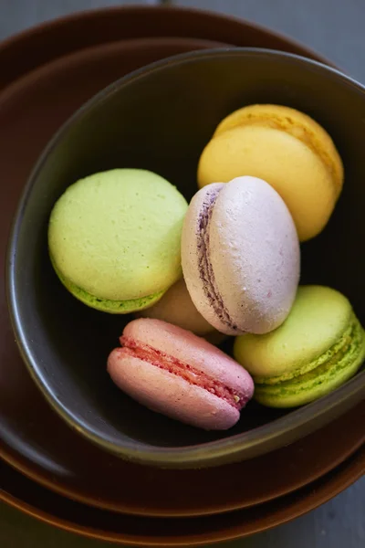 Colorful macaroons on brown plate — Stock Photo, Image