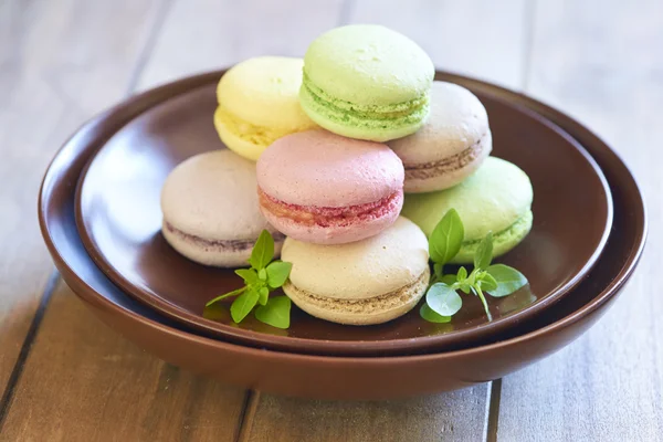 Colorful macaroons on brown plate — Stock Photo, Image