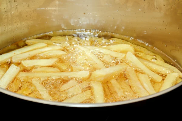 French fries frying in hot oil — Stock Photo, Image