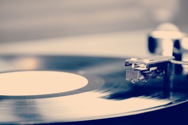 Spinning vinyl record. Motion blur image. Vintage toned. clipart