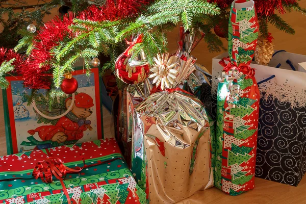 Detail of gifts under decorated christmas tree — Stock Photo, Image