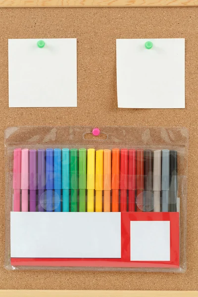 Color markers with notes on cork board — Stock Photo, Image