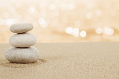 Balance zen stones in sand on white