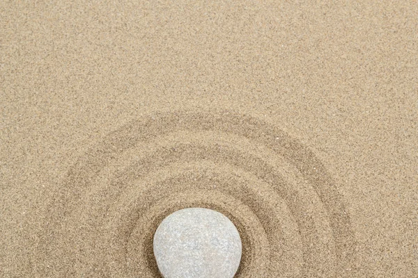 Zen stone in sand with circles — Stock Photo, Image