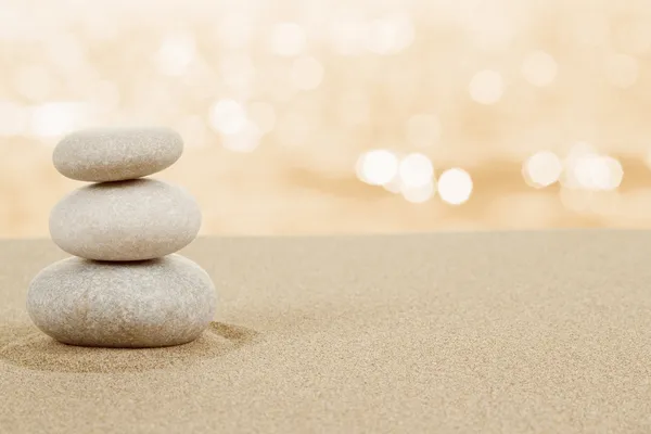 Balance zen stones in sand on white Stockbild