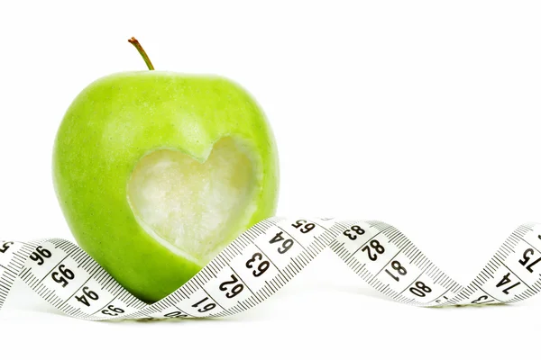 Green apple with a measuring tape and heart symbol isolated — Stock Photo, Image