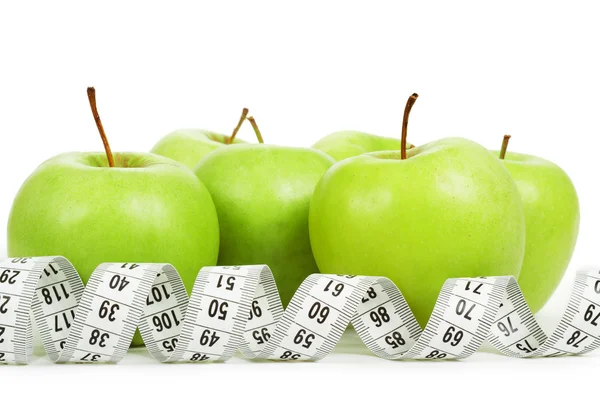 Measuring tape around a green apples as a symbol of diet. — Stock Photo, Image