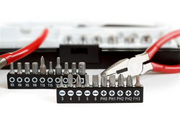 Screwdriver Bit Set on White with pliers — Stock Photo, Image