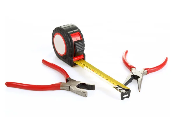Red pliers and measuring tape isolated on white — Stock Photo, Image
