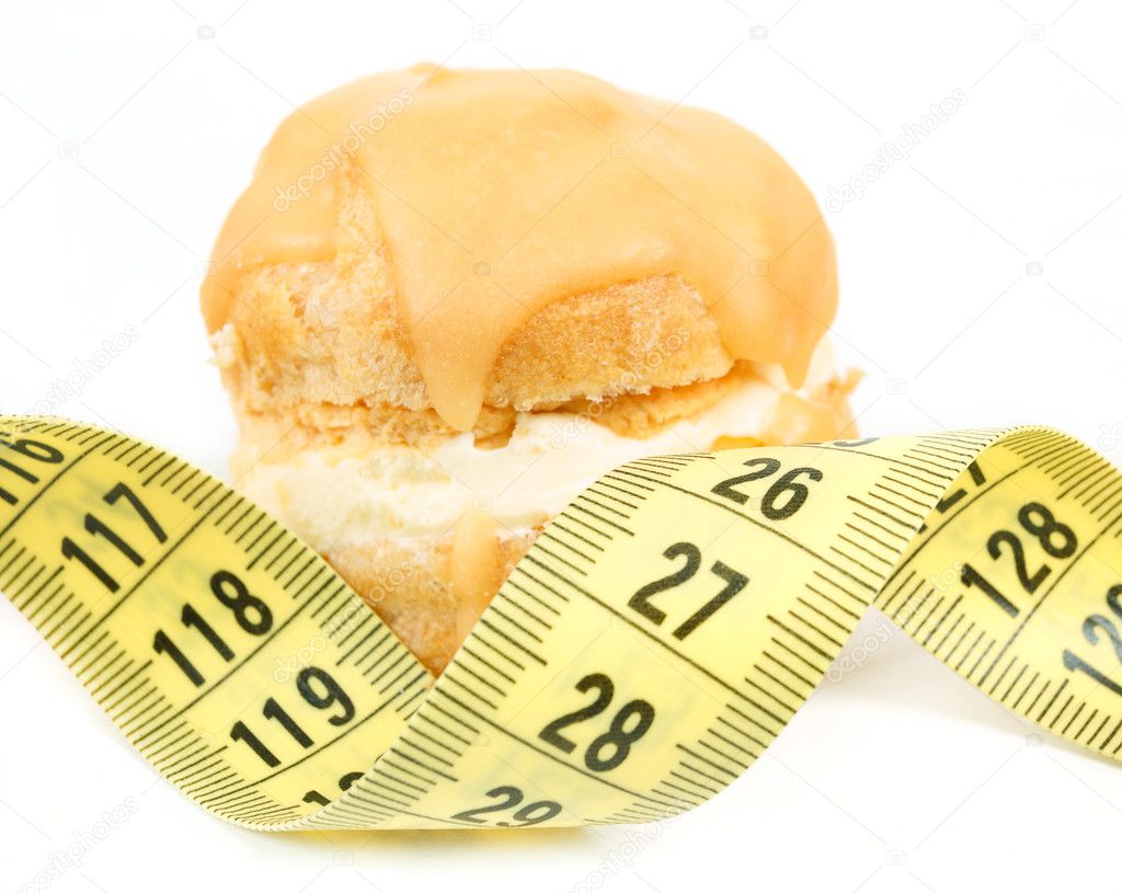 concept of slimming, caramel cake with measuring tape