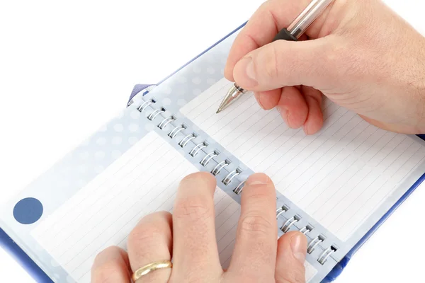 Close-up of hand beginning to write on notes Royalty Free Stock Photos